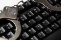 Computer Crime - handcufs on computer keyboard