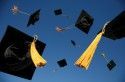 Graduation caps in air