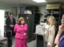County Clerk Debi Russell shows election equipment to Debra Bowen