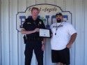 Interim Chief Todd Fordahl presents an award to Jeremy Wood
