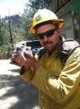 Fire Fighter Nick Gauthier holding owlets resuced in the Carstens Wildfire