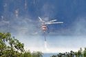 A helicopter taking water from Pine Mountain Lake to fight the fire