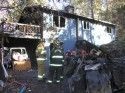 Firefighters outside the Ponderosa Hills home