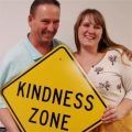 Kindness Coordinator Jim Bergantz, with daughter Jill, hold up a Kindness Zone sign
