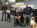 The Sierra Conservation Center (SCC) K9 Unit visits Clarke Broadcasting, Fall 2015 -- left to right, Officer James Lanier with Rooster; Officer Dave Schmittle with River; and Officer Donald Nall with Bo