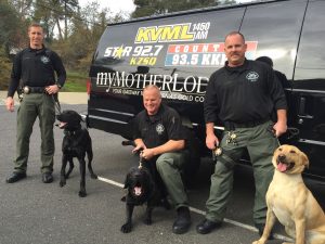 The Sierra Conservation Center (SCC) K9 Unit visits Clarke Broadcasting, Fall 2015 -- left to right, Officer James Lanier with Rooster; Officer Dave Schmittle with River; and Officer Donald Nall with Bo