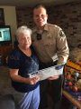 TCSO Dep. Riley with Rae Ann, after the return of $7,000 that may have otherwise been scammed from her.
