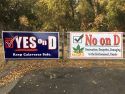 Yes On Measure D and No On Measure D signs hanging near Greenhorn Creek