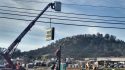 Dollar General sign going up as construction on the store is underway off Highway 26