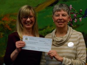 Lynn McCormick, on left, and Donna Schiavo presenting the first $5000 for the purchase of children’s and young adult books