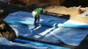Construction contractors are working to install French drains for drainage control.