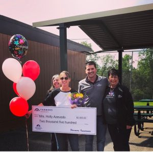 Curtis Creek Third Grade Teacher Holly Acevedo holding $2,500 check surrounded by local Farmers Insurance Agent Leon Curtis and staff members Susan Walbridge and Carolyn King