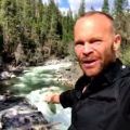 PBS series' Rob on the Road's Rob Stewart at Big Trees State Park pointing to the rushing waters of the Stanislaus River, spring 2017.