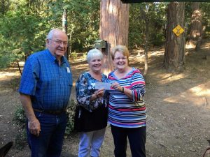 (Left to Right) Dick Mannini of the Black Hat Foundation presents a check to Habitat for Humanity of Tuolumne County's incoming chairwoman Joanne McDonald and outgoing president Margaret McCreary