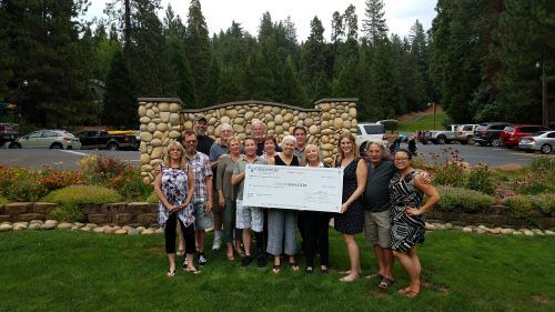 Heisinger family members and friends present a check for more than $12,000 to Adventist Health Sonora’s Home Health and Hospice of the Sierra, proceeds from the annual Dick Heisinger Memorial Golf tournament.