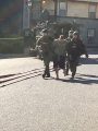 Christopher Clark in handcuffs behind brought out of the building by deputies