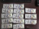 Blue mark from counterfiet money detector pen signaling fake bills
