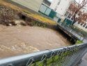Rushing and rising water of Woods Creek near Sonora High School