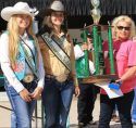2018 Frog Jump Champion Laura-Kitchell, right hoists trophy next to Saddle Queens