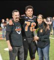 Octavian Hernandez (in the center) at Summerville's Senior Night with his grandparents