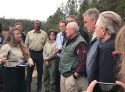 Ag Secretary Perdue (green vest) and Interior Secretary Zinke (directly behind) speak with Forest Service officials in Paradise