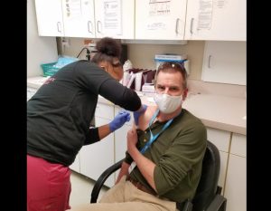 Dr Eric Sergienko receives COVID-19 vaccine