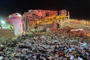 J59 Crash with its cargo of rubber bricks scattered on and near the roadway -- TCFD photo