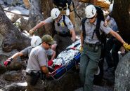 NPS Photo Rescue personnel transporting a patient on a litter from Lower Yosemite Fall boulder field